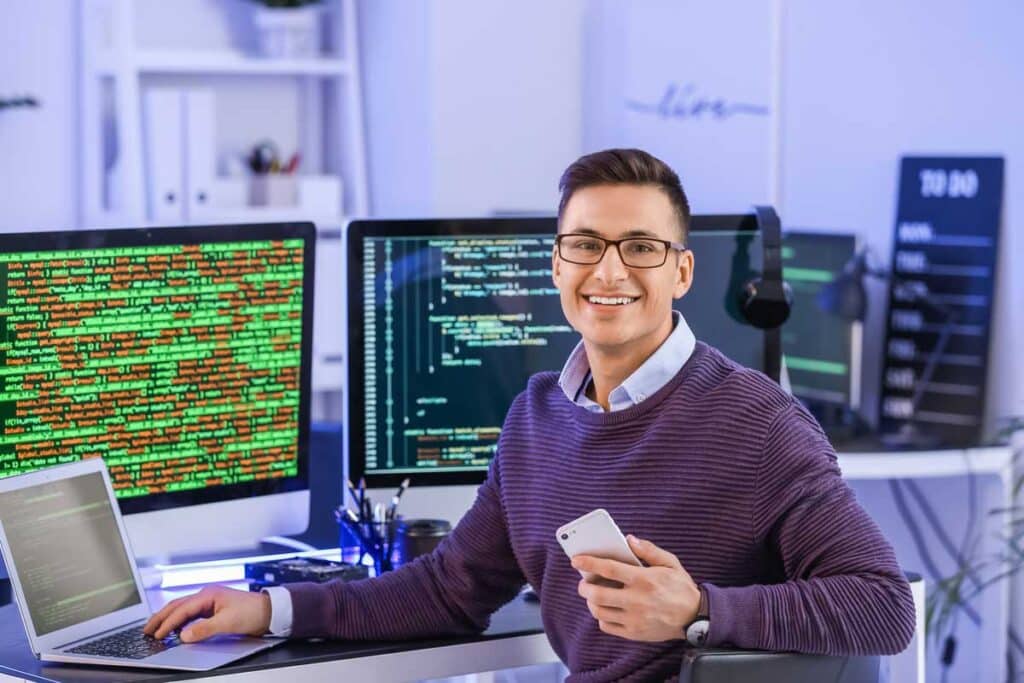 Portrait of male programmer in office at night